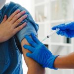 Young Asia lady nurse giving Covid-19 or flu antivirus vaccine s
